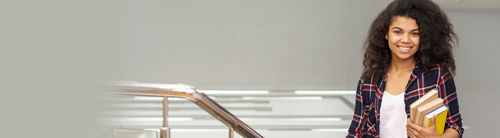 high-angle-girl-stairs-with-stack-books v1